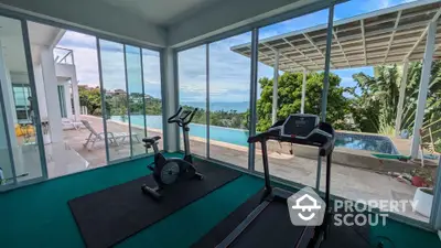 Luxury home gym with stunning ocean view and infinity pool