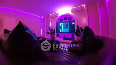 Luxurious living room with ambient purple lighting and modern entertainment setup.