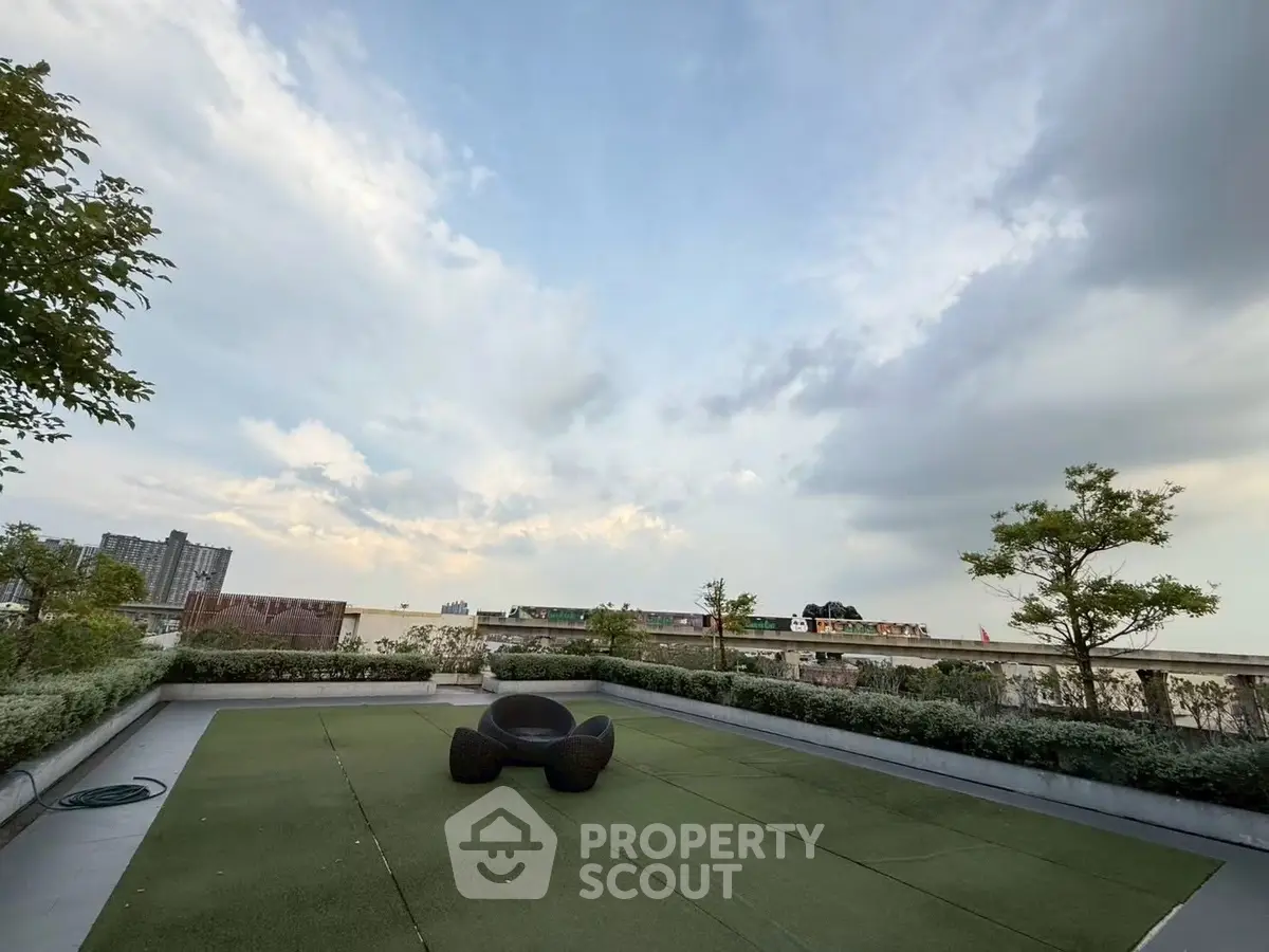 Stunning rooftop garden with panoramic city views and modern seating area.