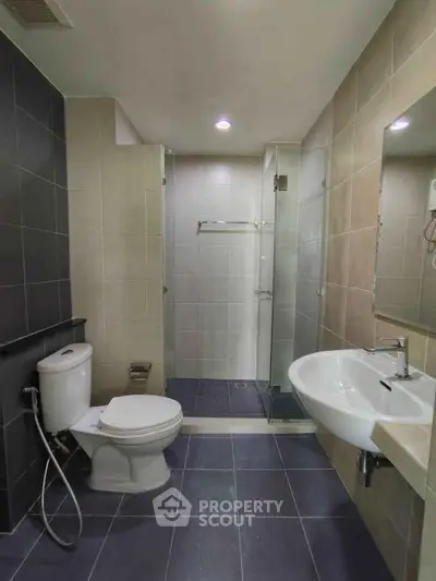 Modern bathroom with sleek fixtures and glass shower enclosure