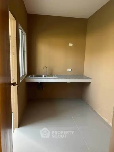 Minimalist kitchen with single sink and countertop in compact space