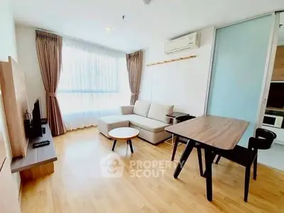 Bright and modern living room with wooden flooring and stylish furniture in a cozy apartment.