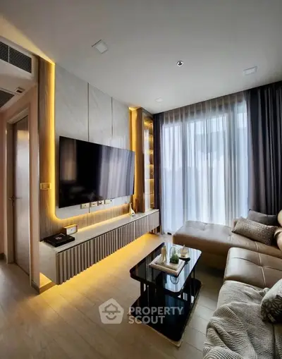 Modern living room with sleek design, featuring a large TV, ambient lighting, and comfortable seating.