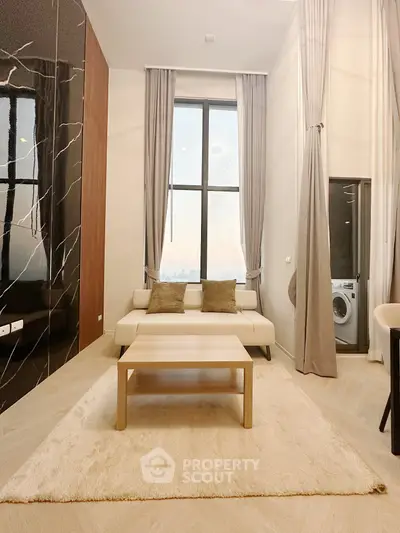 Modern living room with elegant decor and large window view