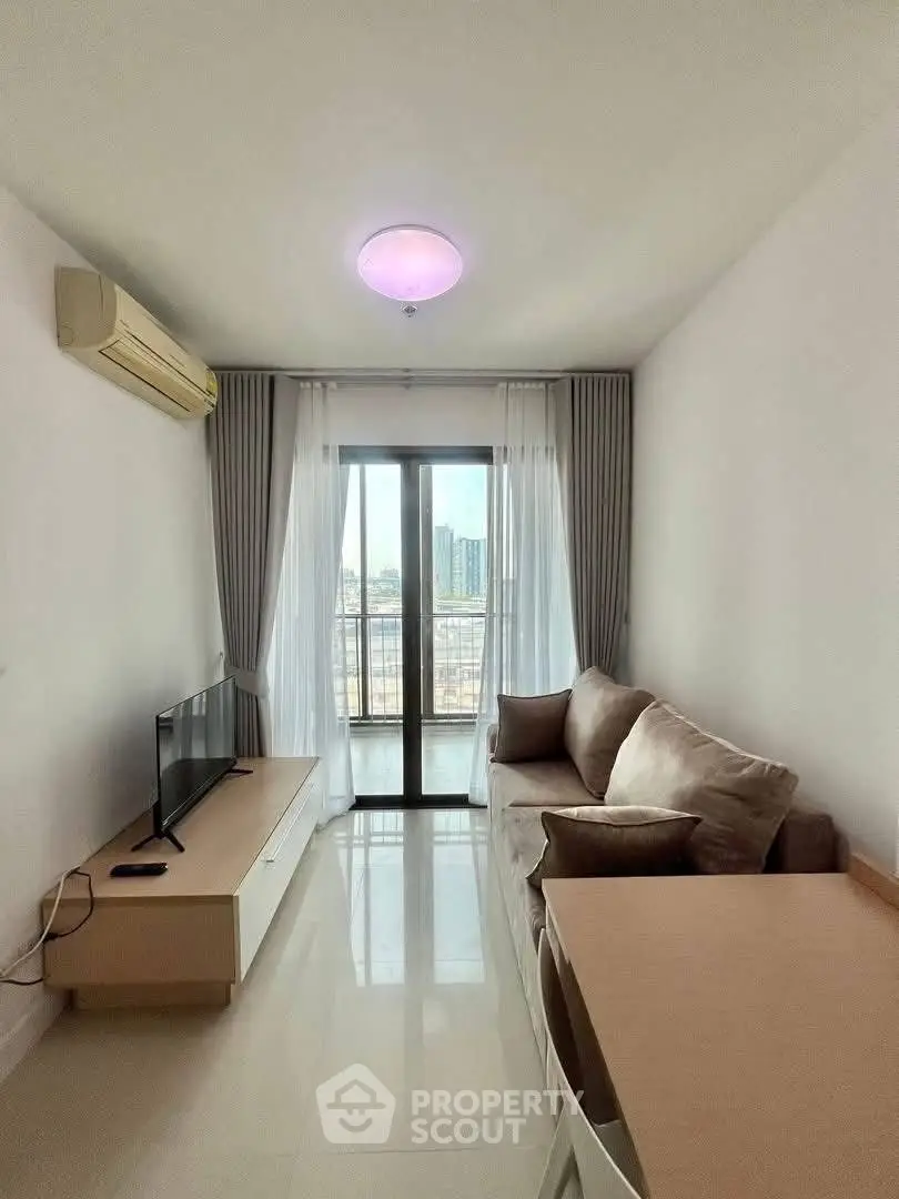 Modern living room with city view, cozy sofa, and sleek TV setup.