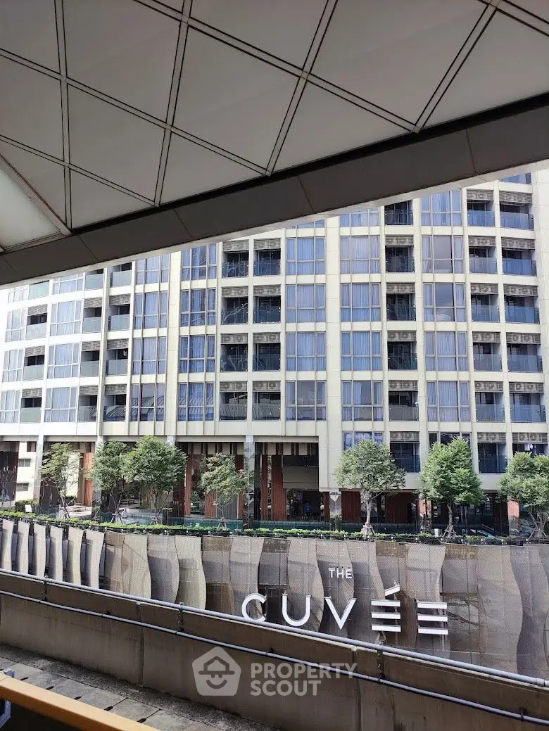 Modern urban building exterior with sleek design and lush greenery at The Cuvée.