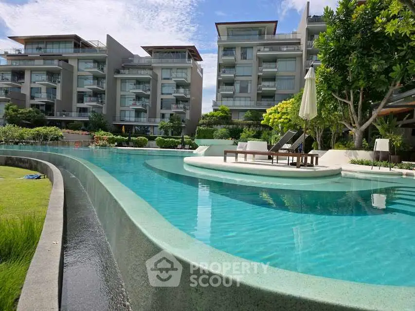 Luxurious residential complex with stunning pool and modern architecture.