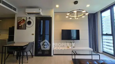 Modern living room with stylish lighting and large windows in a high-rise apartment.