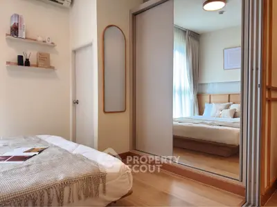 Cozy bedroom with mirrored closet and warm lighting