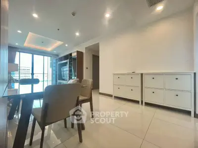 Spacious modern living room with elegant dining area and large windows for natural light.