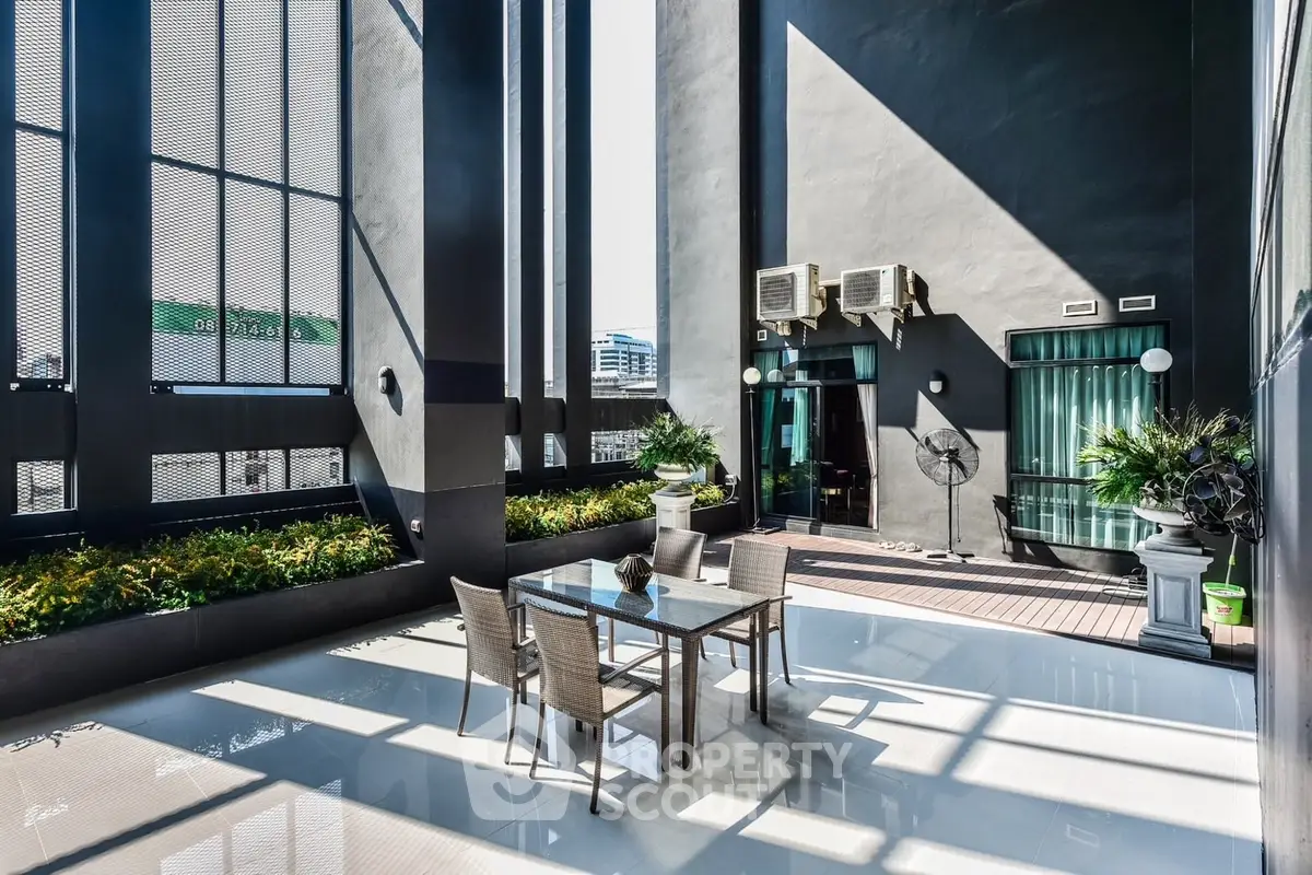 Luxurious rooftop terrace with modern design and city views, perfect for outdoor dining and relaxation.