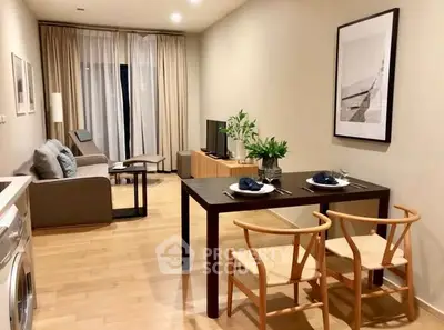 Modern open-plan living room with dining area, featuring stylish furniture and natural light.