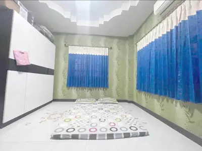 Spacious bedroom with minimalist decor and large windows for natural light.