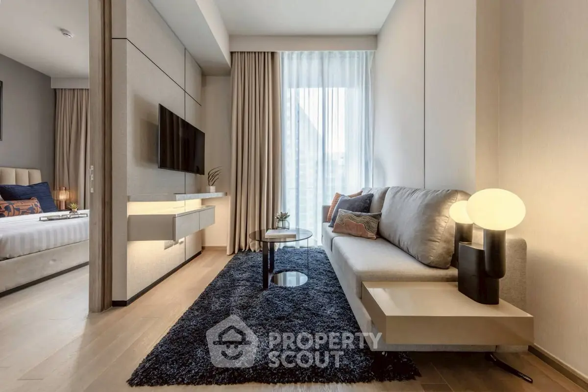 Modern living room with sleek design and cozy ambiance, featuring a plush sofa and stylish decor.