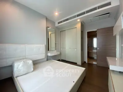 Modern bedroom with sleek design and built-in storage in a contemporary apartment.