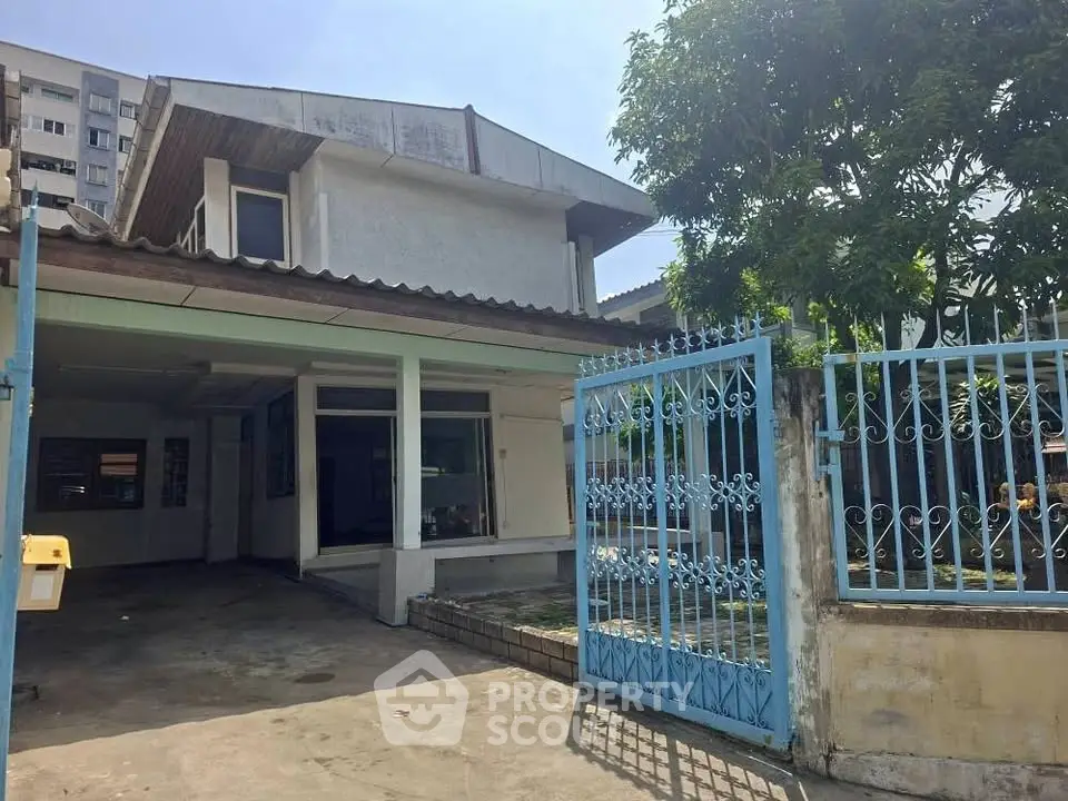 Charming suburban house with gated entrance and spacious driveway, perfect for family living.