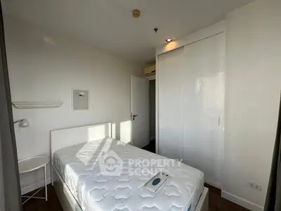 Cozy bedroom with white decor and built-in wardrobe, perfect for minimalist living.
