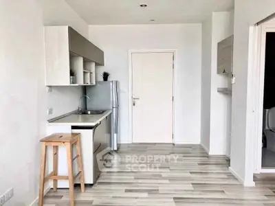 Modern minimalist kitchen with sleek cabinetry and light wood flooring, perfect for contemporary living.