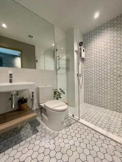 Modern bathroom with hexagonal tiles and glass shower enclosure