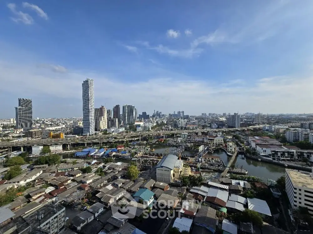 Stunning cityscape view showcasing urban skyline and residential areas under a clear blue sky.