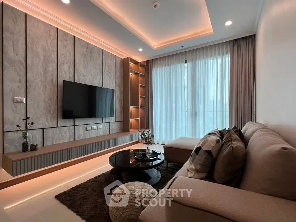 Modern living room with stylish decor and cozy seating area, featuring a sleek TV setup and ambient lighting.