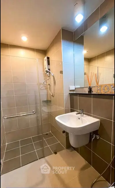 Modern bathroom with sleek fixtures and spacious shower area