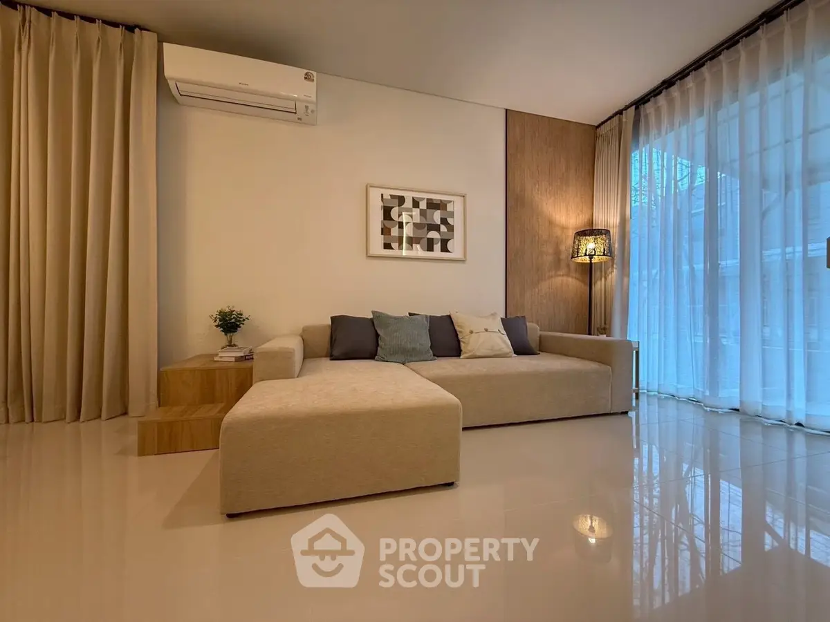 Spacious modern living room with elegant decor and large windows for natural light.