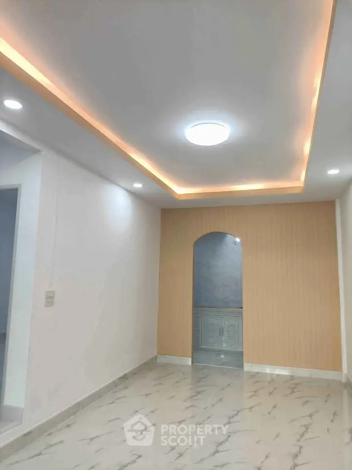 Modern interior with recessed lighting and marble flooring in a stylish living space.