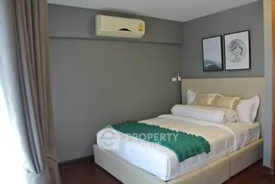 Cozy bedroom with modern decor and air conditioning in a stylish apartment.