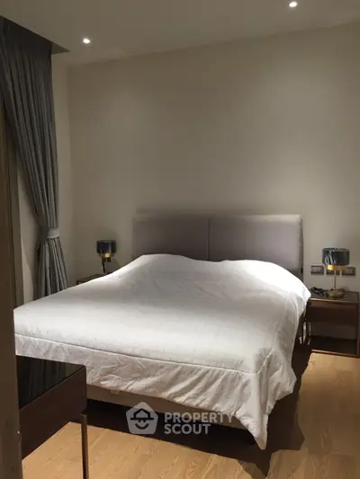 Elegant bedroom with modern decor and cozy lighting, featuring a comfortable bed and stylish nightstands.