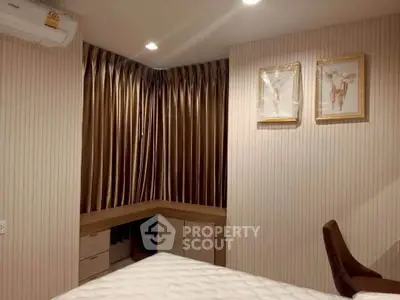 Cozy bedroom with elegant curtains and stylish decor, perfect for relaxation.