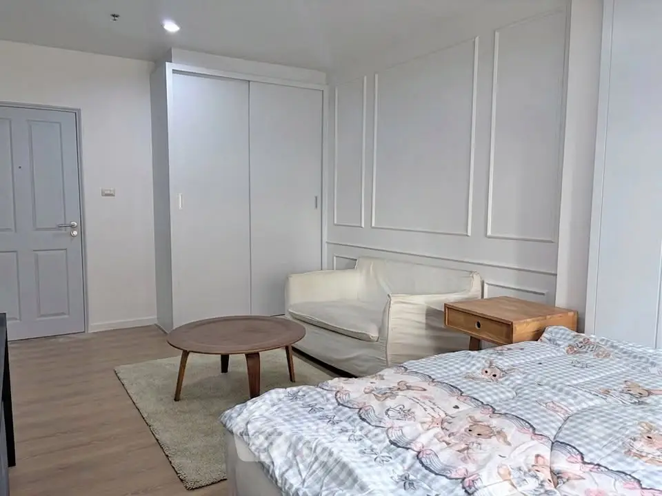 Cozy bedroom with modern decor and comfortable seating area