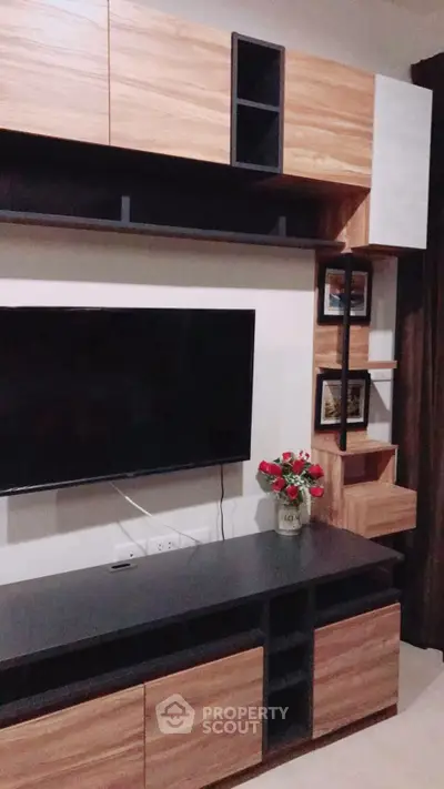 Modern living room with sleek wooden entertainment unit and mounted TV, perfect for stylish home decor.