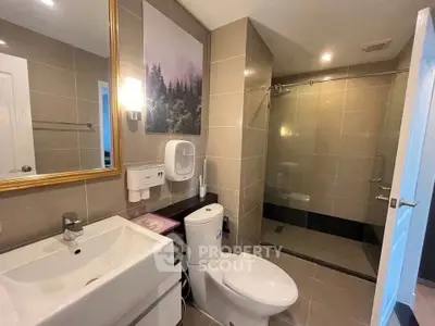 Modern bathroom with sleek fixtures and spacious shower in a contemporary home.