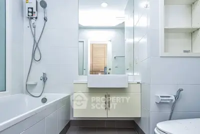 Modern bathroom with sleek fixtures and bathtub in a bright, minimalist design.