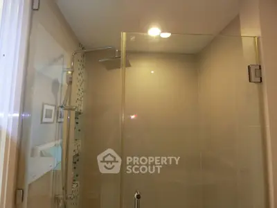 Modern bathroom with glass shower enclosure and rainfall showerhead