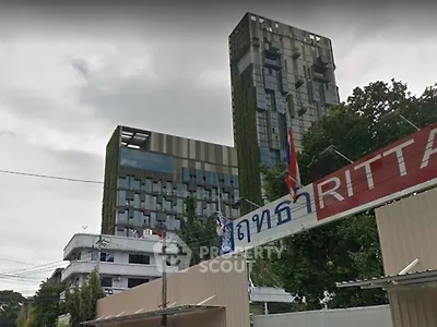 Modern urban building with unique architectural design and lush greenery facade.