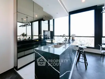 Luxurious modern kitchen with sleek black countertops and panoramic city views.