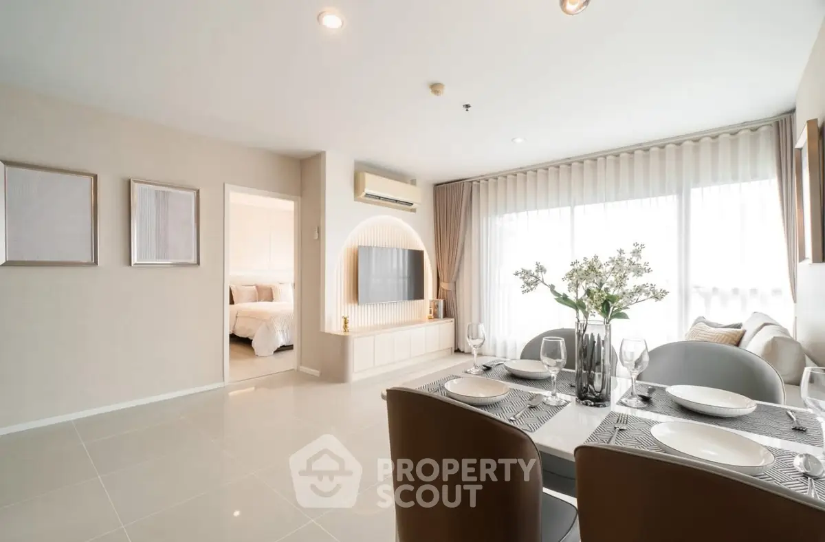 Modern open-plan living and dining area with elegant decor and natural light.