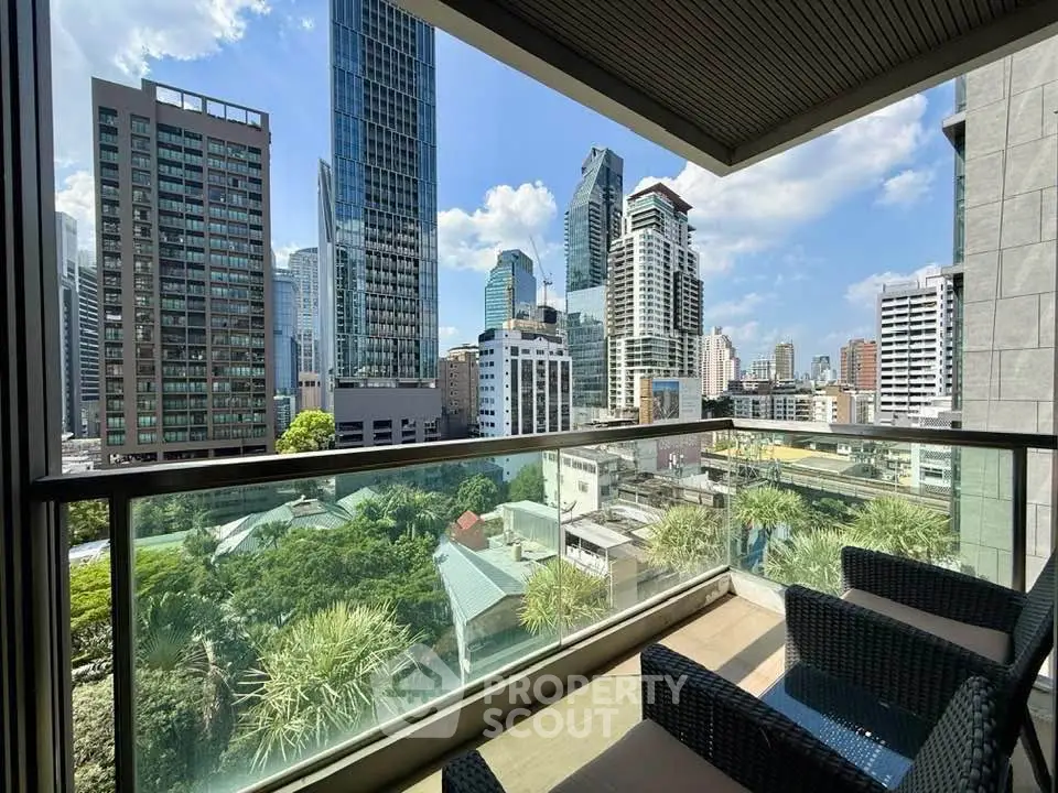Stunning cityscape view from a modern balcony with comfortable seating, perfect for urban living.