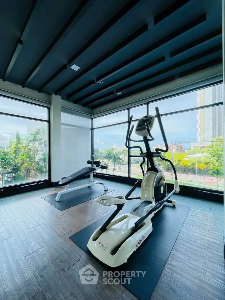 Modern gym with city view and exercise equipment in luxury building