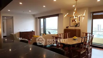 Luxurious open-plan living and dining area with modern lighting and stunning city view.