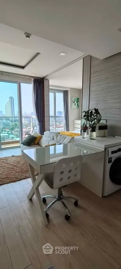 Modern apartment interior with study area and stunning city view from large windows.