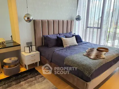 Luxurious modern bedroom with plush bed and stylish decor in high-rise apartment.