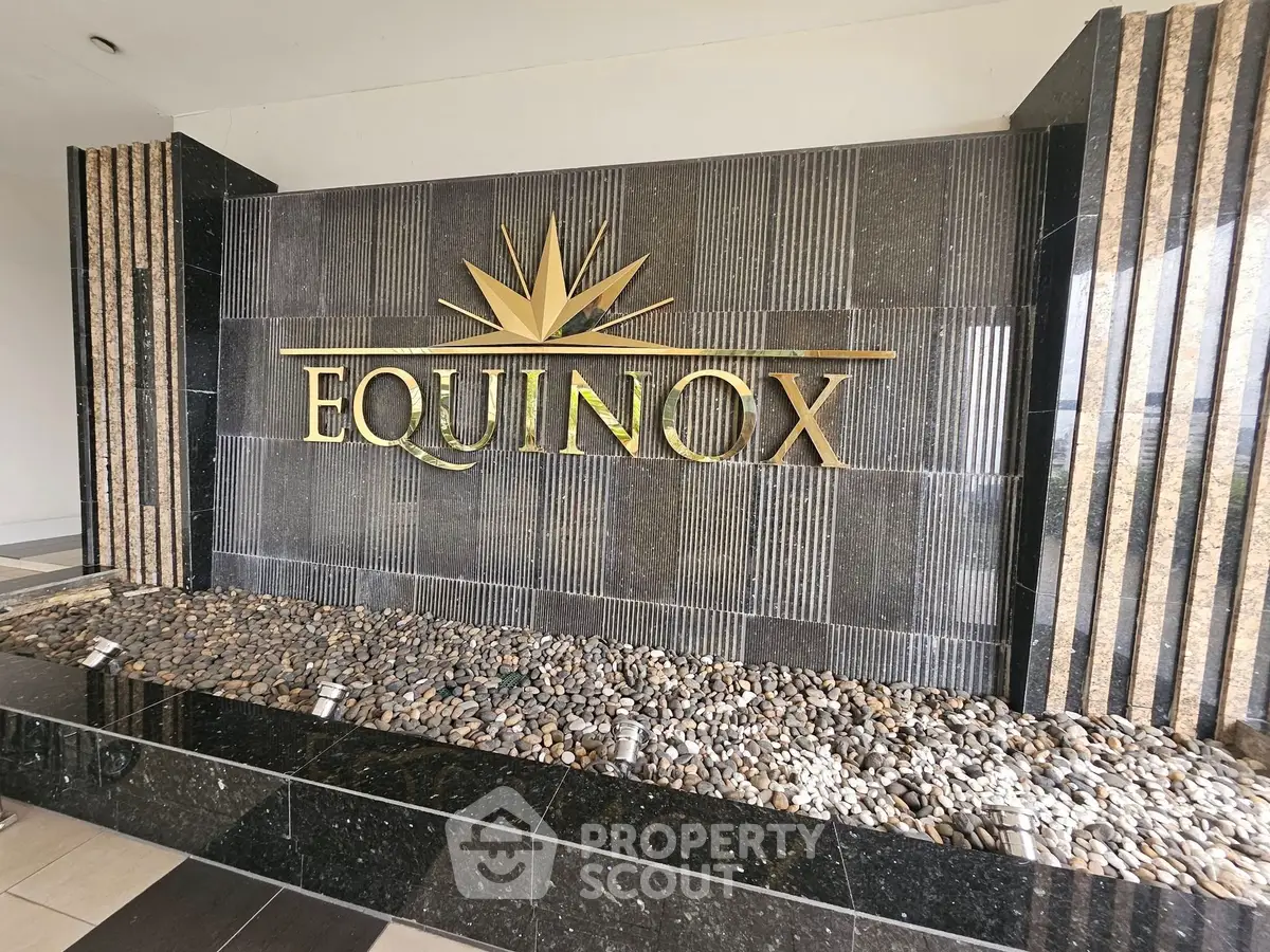 Luxurious Equinox building entrance with elegant stone design and modern aesthetics.