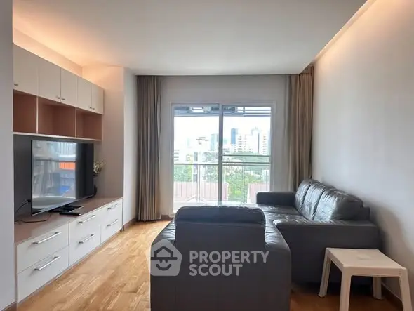 Spacious living room with modern furniture and city view, perfect for relaxation and entertainment.