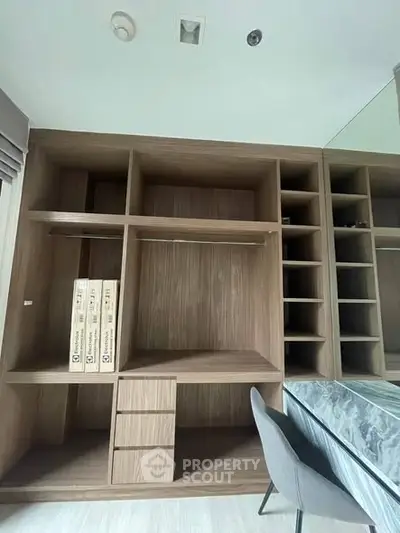Modern study area with built-in wooden shelves and desk, perfect for home office setup.