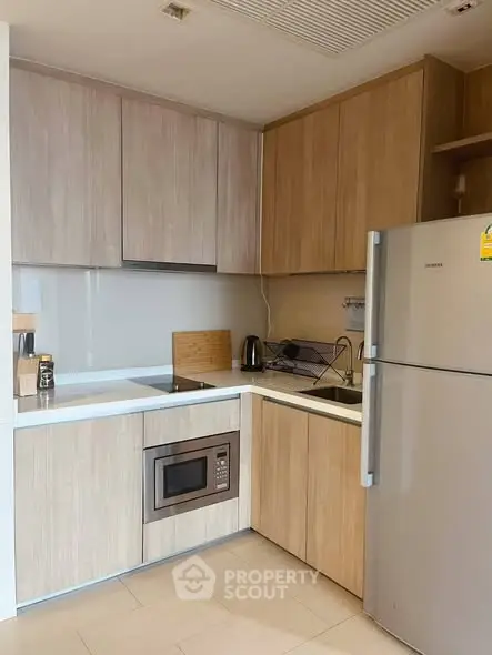 Modern kitchen with sleek cabinetry and built-in appliances in a stylish apartment.