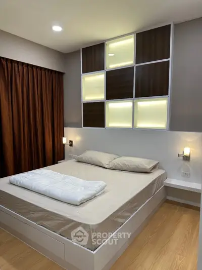 Modern bedroom with stylish lighting and wooden flooring