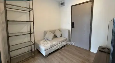 Cozy living room with modern sofa and sleek shelving unit, perfect for urban living.